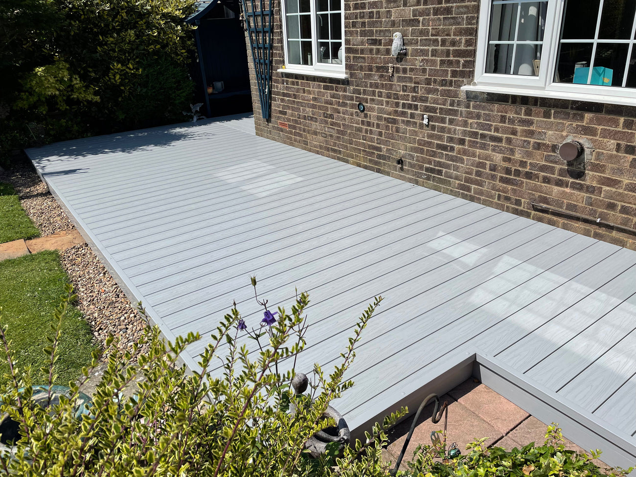 Grey plastic decking boards outside a house
