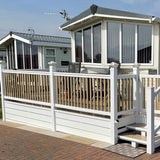 An example of a fully installed 12' x 6' end patio with steps and a gate in the white colour