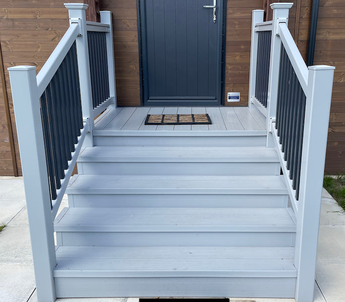 Light grey box steps in front of a static caravan