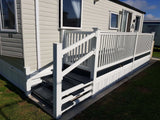 An example of a fully installed 6' x 3' 3" entry platform with steps and a gate in the white colour
