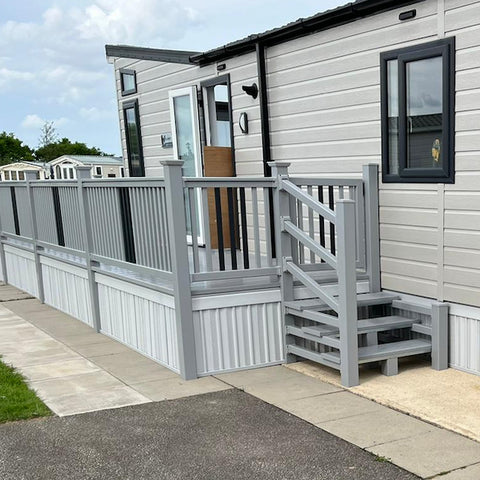 An example of a fully installed 18' x 6' side patio with steps and a gate in the light grey colour